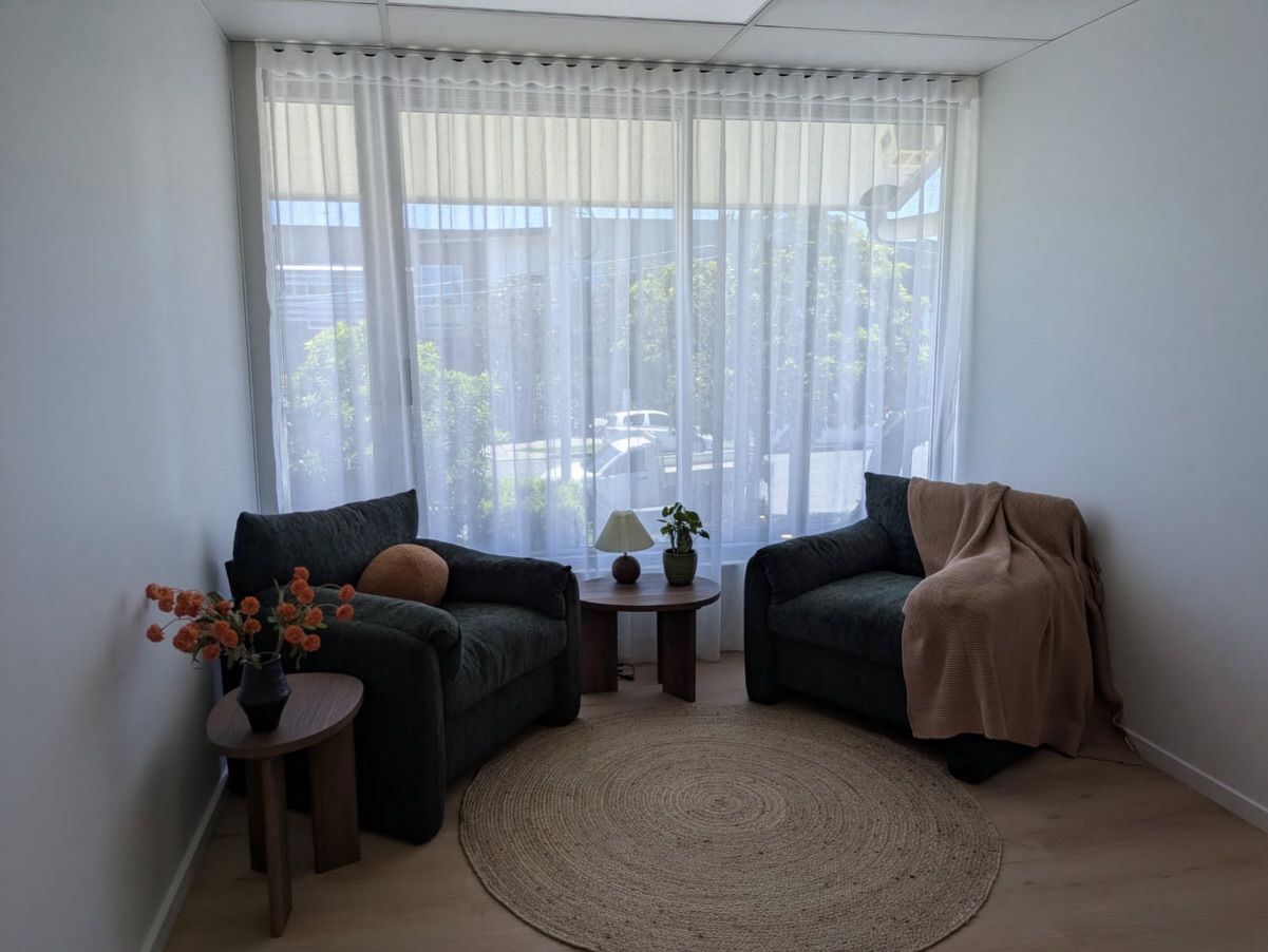 A Cozy Sitting Area With Two Dark Armchair — Totally Flooring Gold Coast In Bundall, QLD