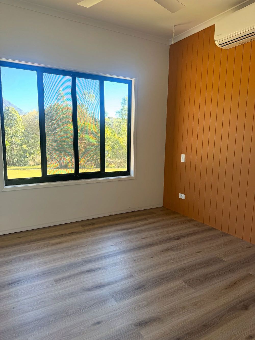 An empty room with recently installed timber flooring