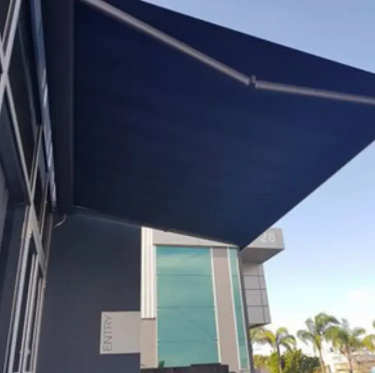 A White House With a Black Awning on the Side of It — Totally Flooring Gold Coast In Bundall, QLD