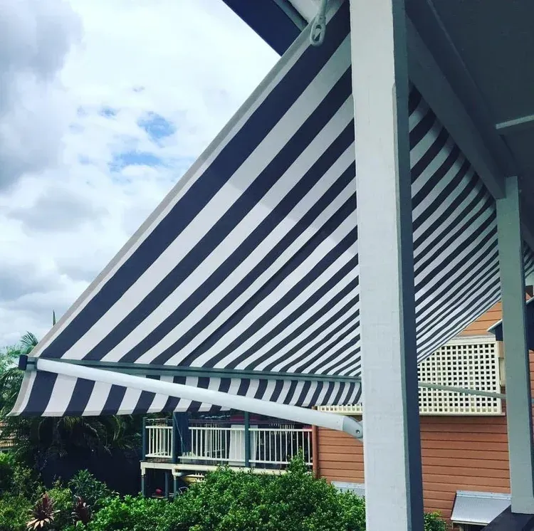 A White House With a Black Awning on the Side of It — Totally Flooring Gold Coast In Bundall, QLD