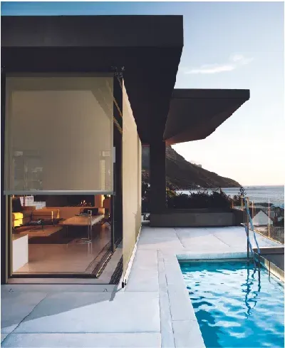 A White House With a Black Awning on the Side of It — Totally Flooring Gold Coast In Bundall, QLD