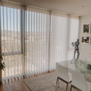 A Sunlit Room With Floor-to-ceiling Sheer Vertical Blinds — Totally Flooring Gold Coast In Bundall, QLD