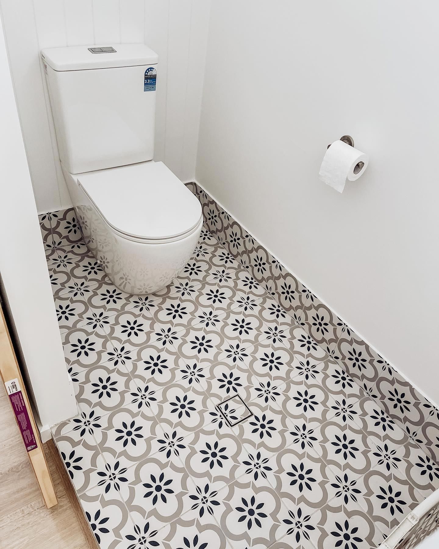 A toilet with recently installed bathroom tiles
