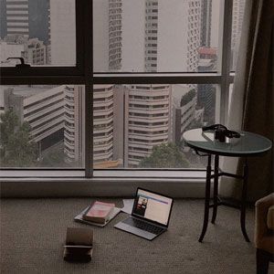 A Laptop Computer is Sitting on the Floor in Front of a Large Window — Totally Flooring Gold Coast In Bundall, QLD
