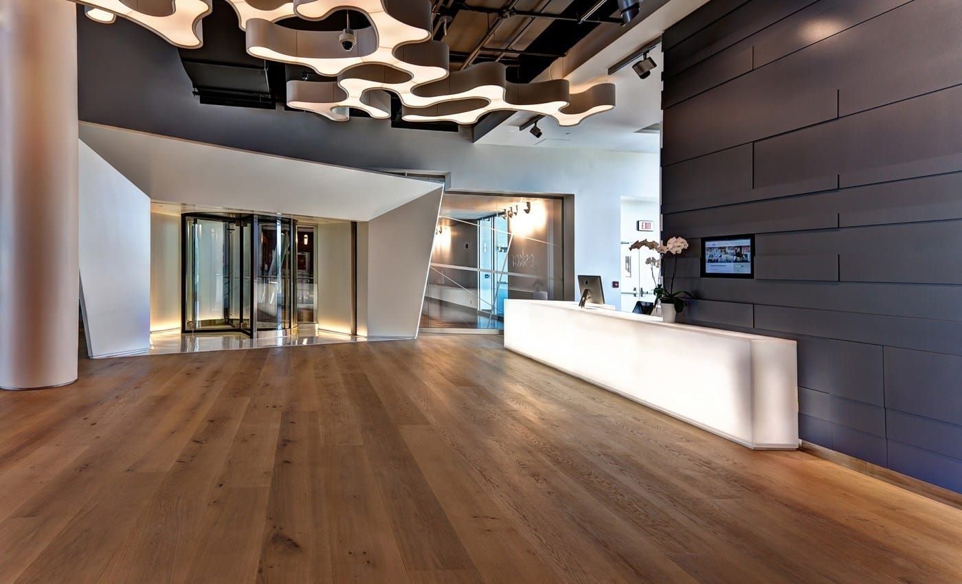 A Close Up of a Wooden Floor in a Living Room With a Fireplace — Totally Flooring Gold Coast In Bundall, QLD