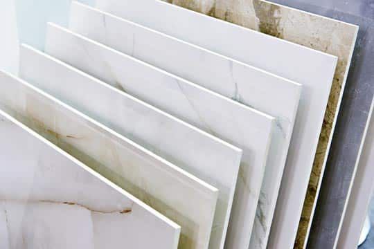 Stack of White Marble Tiles or Panels Leaning Together — Totally Flooring Gold Coast In Bundall, QLD