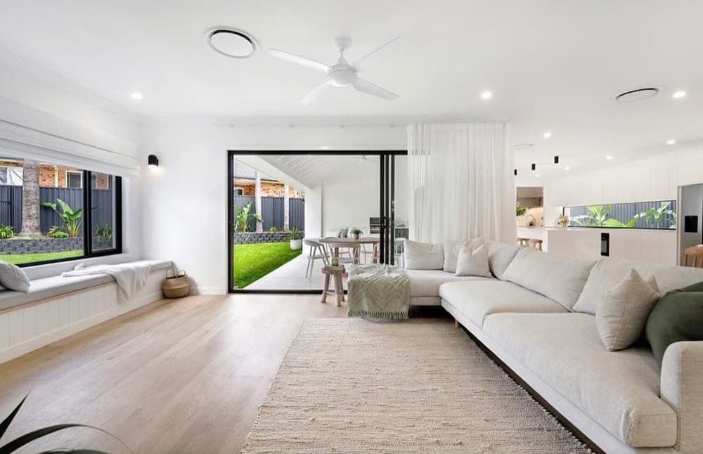 A Living Room With a White Couch and a Ceiling Fan — Totally Flooring Gold Coast In Bundall, QLD