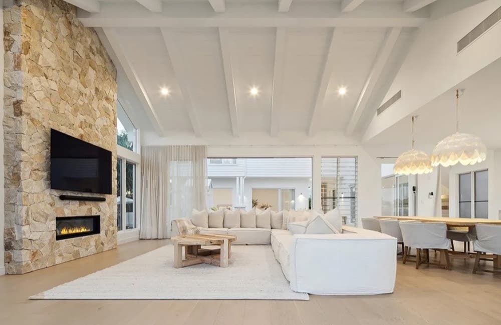 A Living Room With a Couch, Fireplace and Television — Totally Flooring Gold Coast In Bundall, QLD