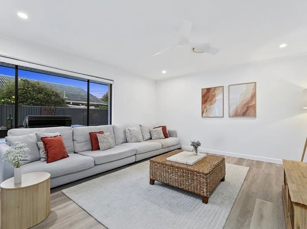 A Living Room With a Large Couch and a Coffee Table — Totally Flooring Gold Coast In Bundall, QLD