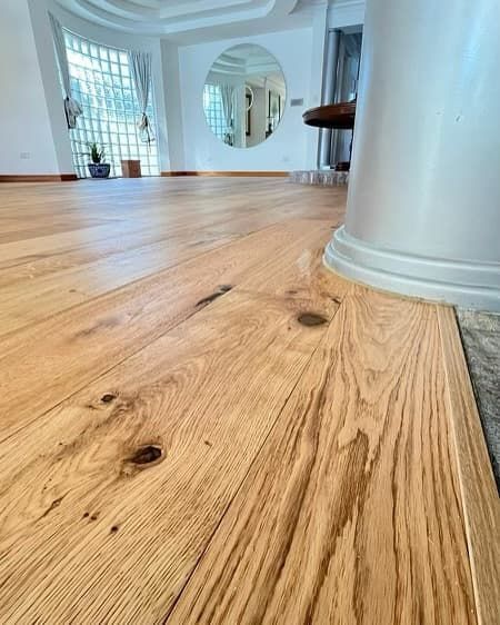 A Close Up of a Wooden Floor in a Living Room — Totally Flooring Gold Coast In Bundall, QLD
