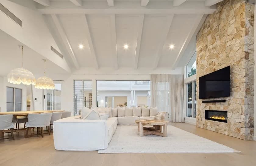 A Living Room With a Couch, Fireplace, and Television — Totally Flooring Gold Coast In Bundall, QLD