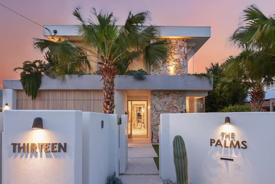 The Front of a House With a Sign That Says the Palms — Totally Flooring Gold Coast In Bundall, QLD