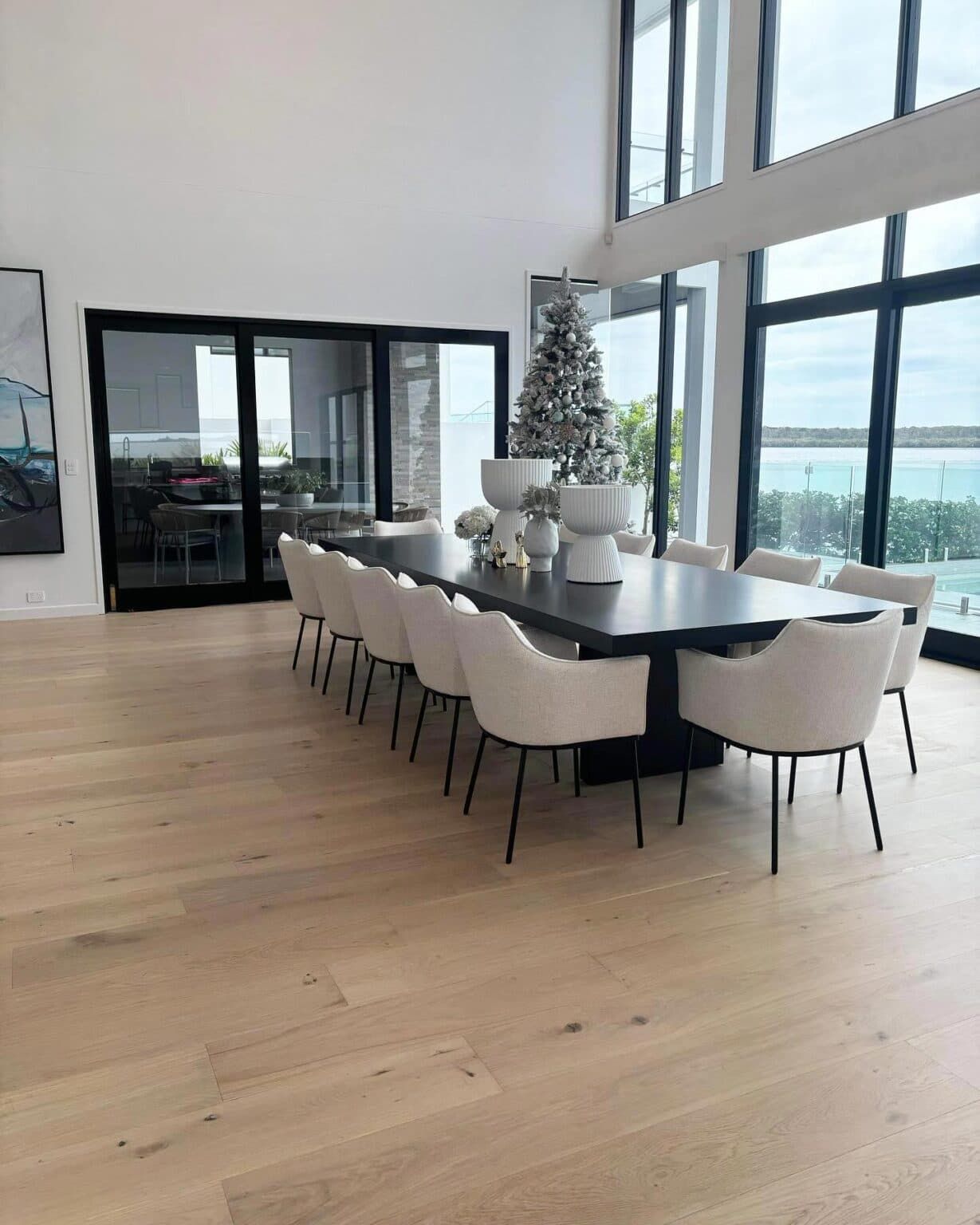A Large Dining Room With a Table and Chairs and a Christmas Tree — Totally Flooring Gold Coast In Bundall, QLD