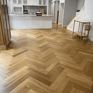 A Kitchen With a Wooden Floor in a Herringbone Pattern — Totally Flooring Gold Coast In Bundall, QLD