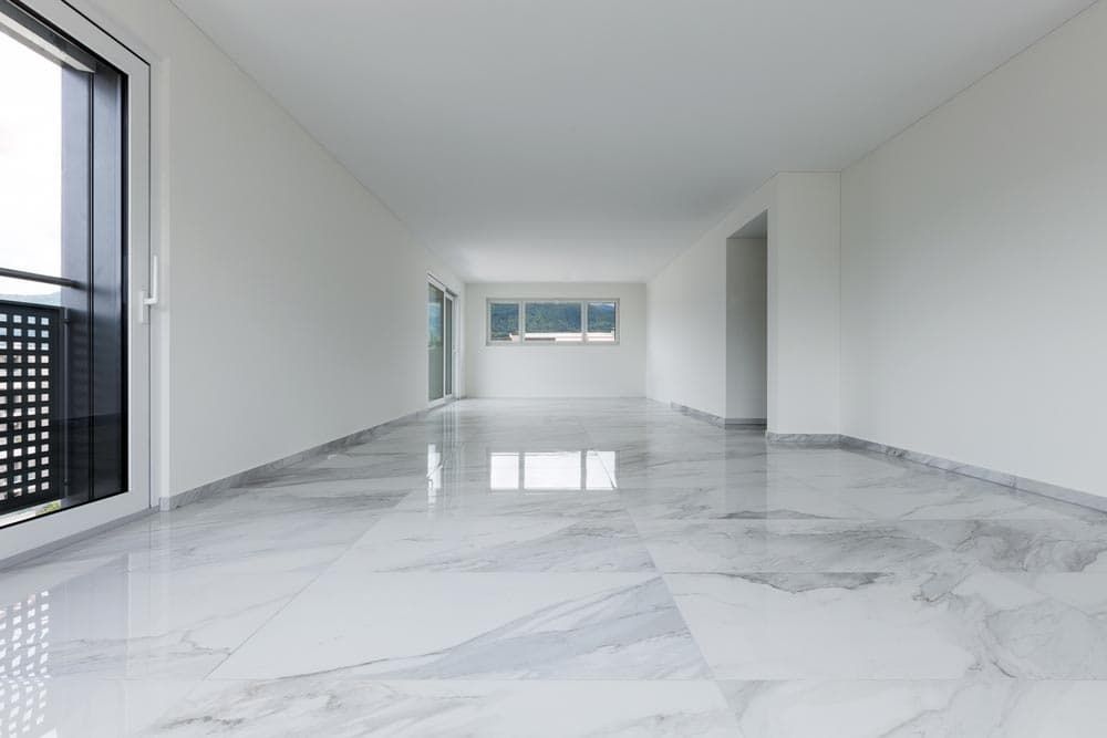 A Large Empty Room With Marble Floors and White Walls — Totally Flooring Gold Coast In Bundall, QLD
