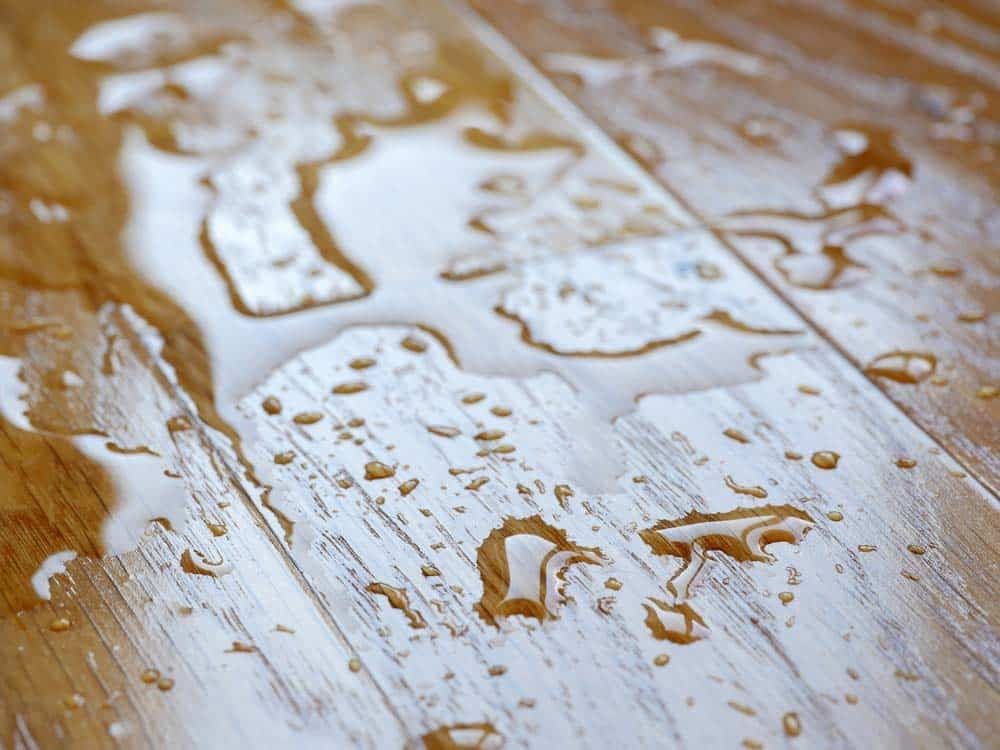 A Close Up of a Wooden Floor With Water Drops on It — Totally Flooring Gold Coast In Bundall, QLD