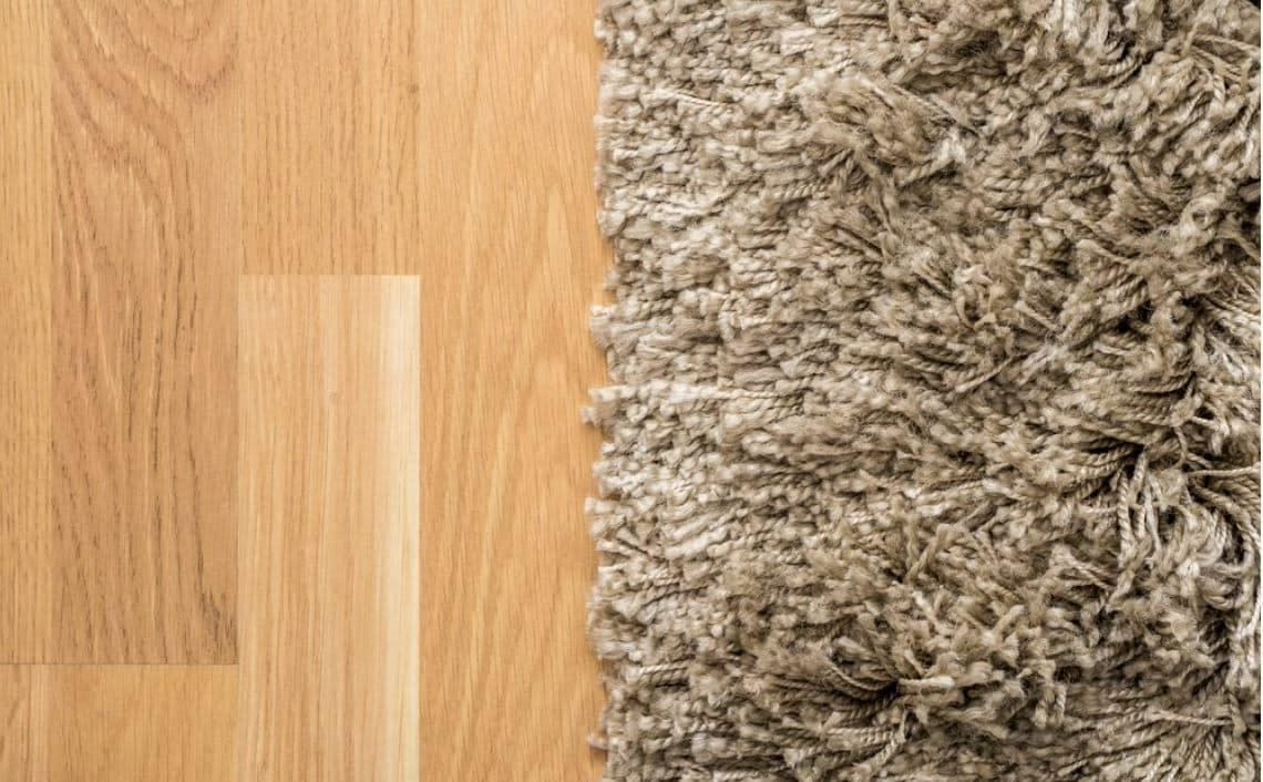 A Close Up of a Rug on a Wooden Floor Next to a Wooden Floor — Totally Flooring Gold Coast In Browns Plains, QLD