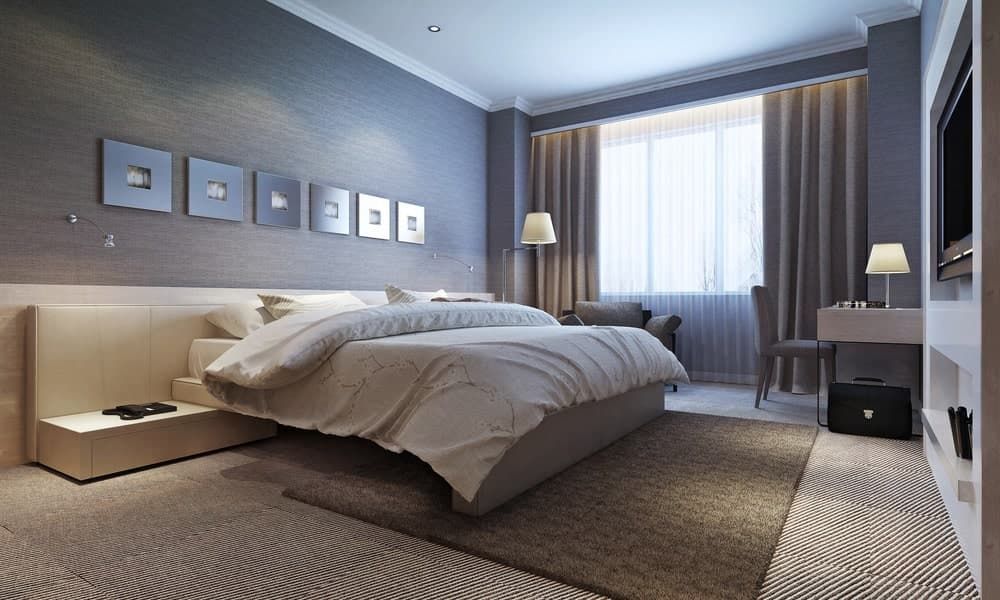 A Bedroom With a Large Bed, a Desk, a Television and a Rug — Totally Flooring Gold Coast In Bundall, QLD