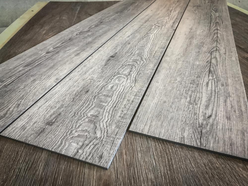 Three Pieces of Wood Are Laying on Top of Each Other on a Table — Totally Flooring Gold Coast In Bundall, QLD