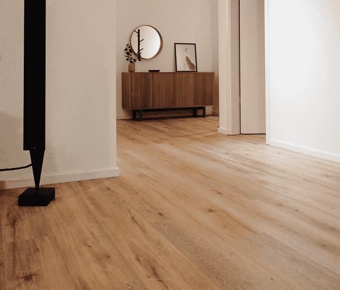 A Hallway With a Wooden Floor and a Mirror on the Wall — Totally Flooring Gold Coast In Bundall, QLD
