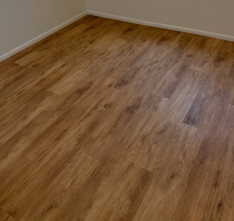 A Room With a Wooden Floor and White Walls — Totally Flooring Gold Coast In Bundall, QLD
