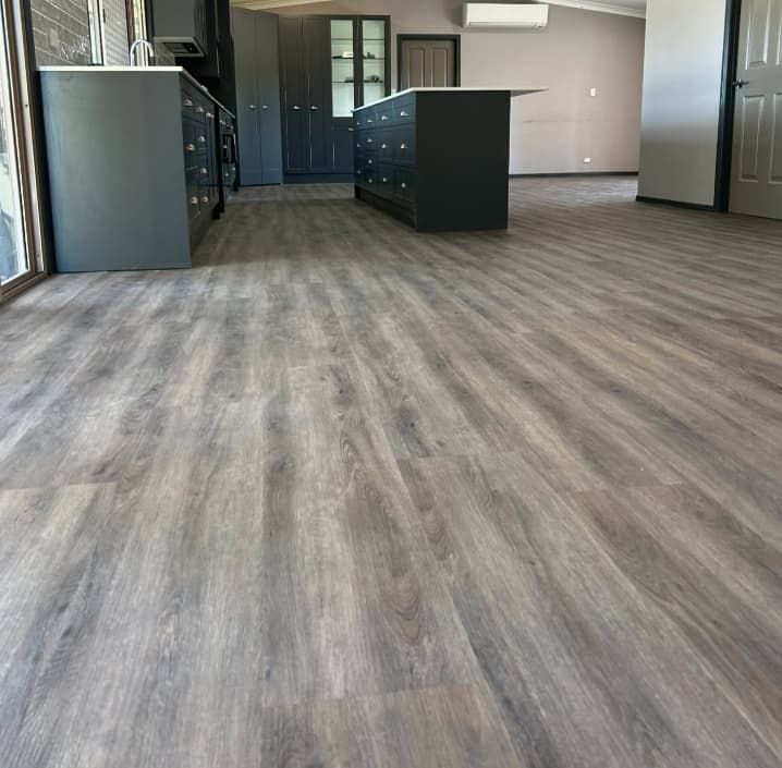 A Kitchen With a Wooden Floor and a Large Island — Totally Flooring Gold Coast In Bundall, QLD