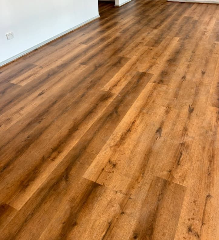 A Close Up of a Wooden Floor in a Living Room — Totally Flooring Gold Coast In Bundall, QLD