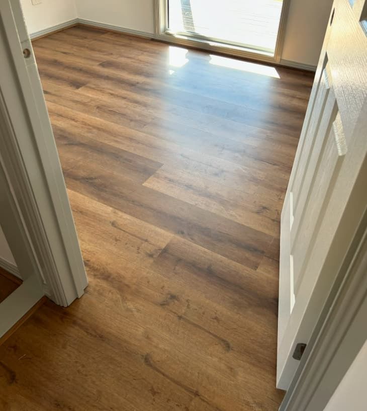 A Room With a Wooden Floor and a White Door — Totally Flooring Gold Coast In Bundall, QLD