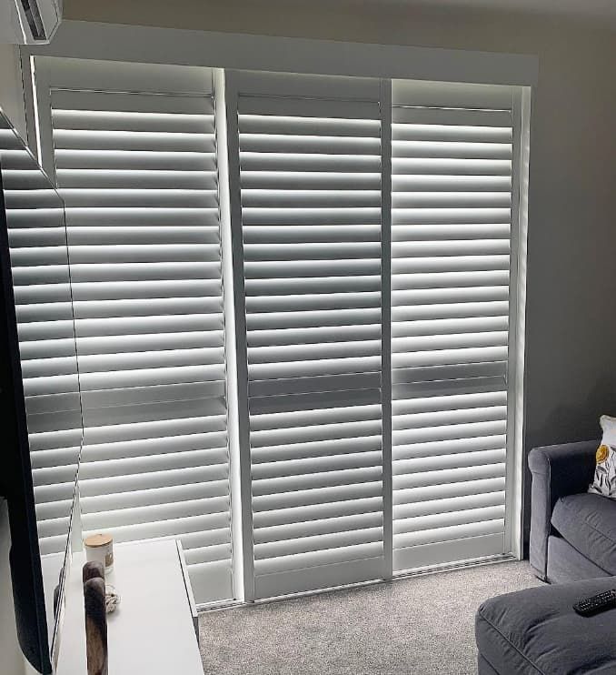 A Living Room With a Couch, Television, and Shutters on the Windows — Totally Flooring Gold Coast In Bundall, QLD
