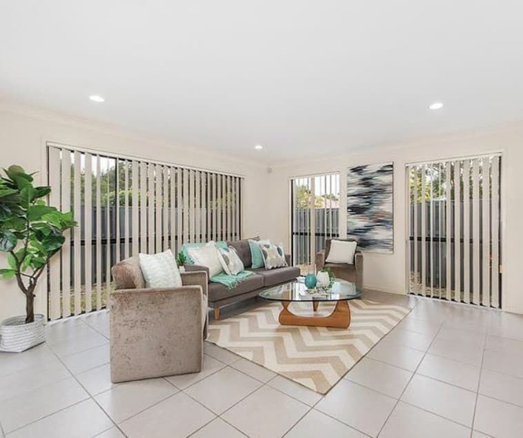 A Living Room With a Couch, Chairs, and a Coffee Table — Totally Flooring Gold Coast In Bundall, QLD