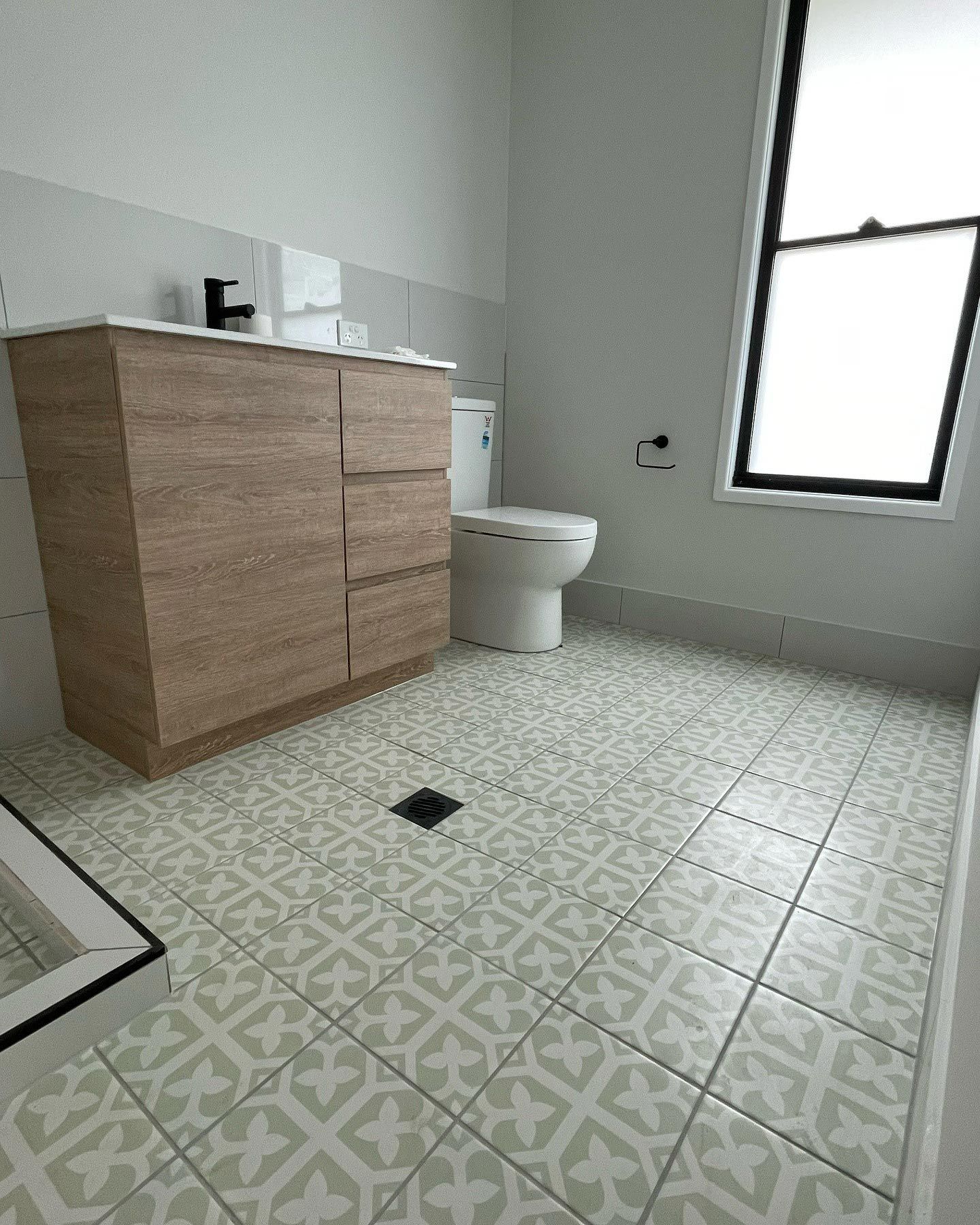 Recently installed floor tiles in a Gold Coast bathroom