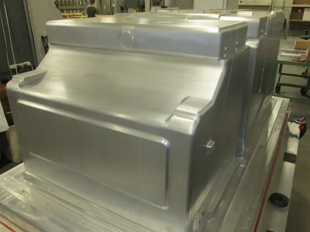 Metal industrial machine with a brushed aluminum finish in a workshop