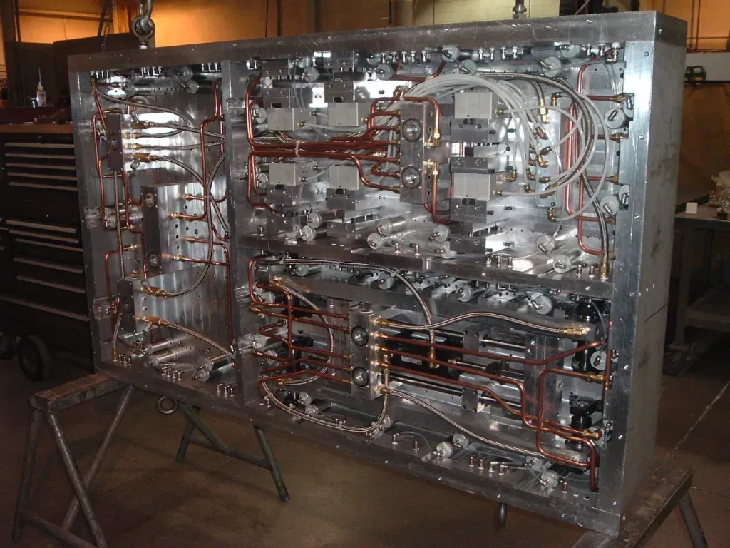 Open electronic chassis with exposed wires, circuit boards, and components on a workbench