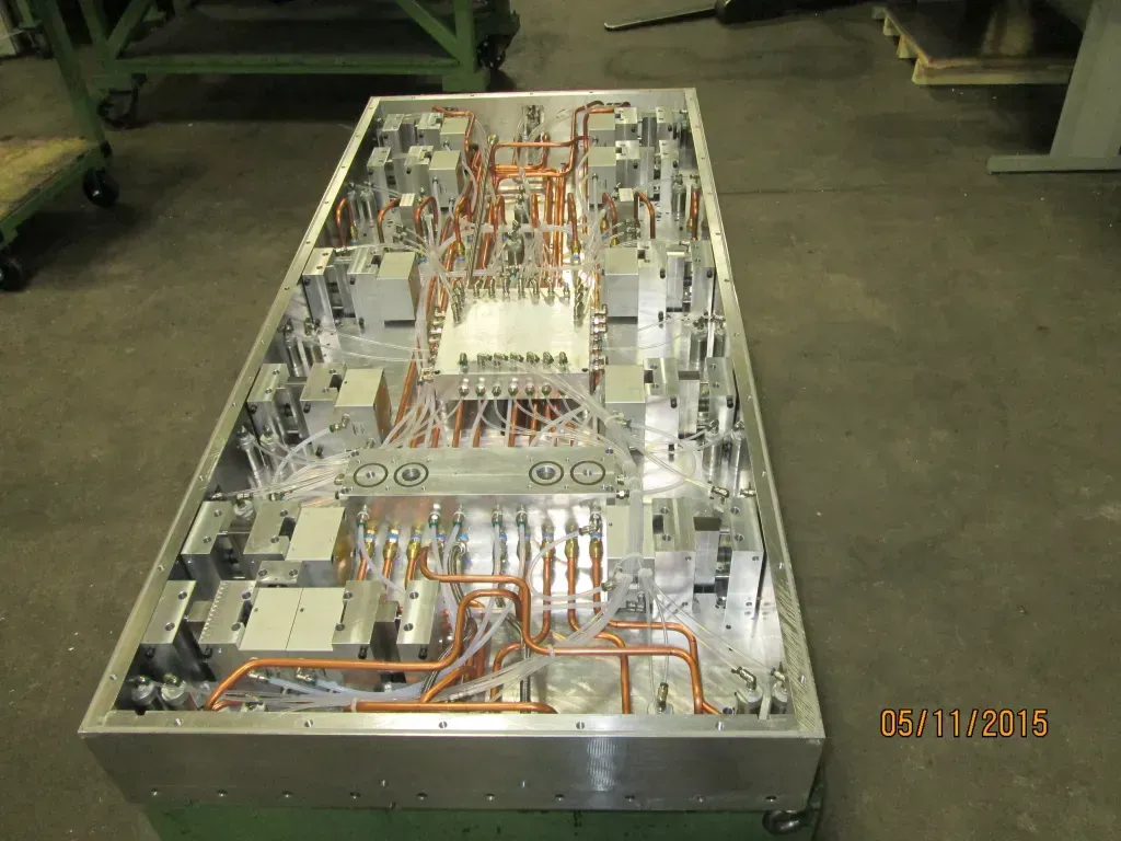 Open equipment chassis with exposed wiring and components on a factory floor