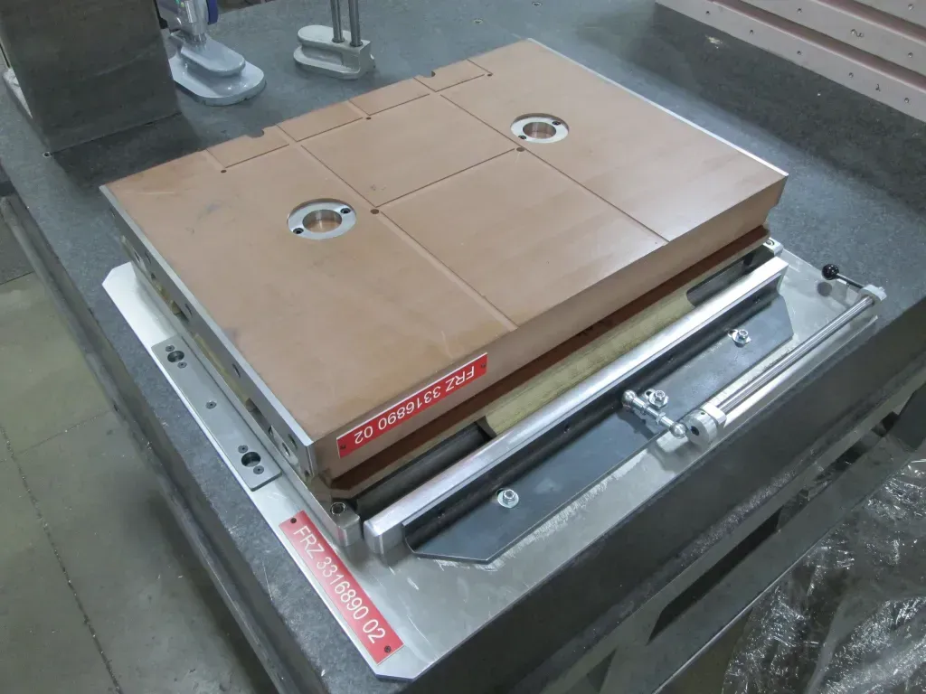 Brown cardboard box on a metal platform conveyor or packaging machine in an industrial setting