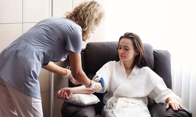 a woman being given an IV by a nurse
