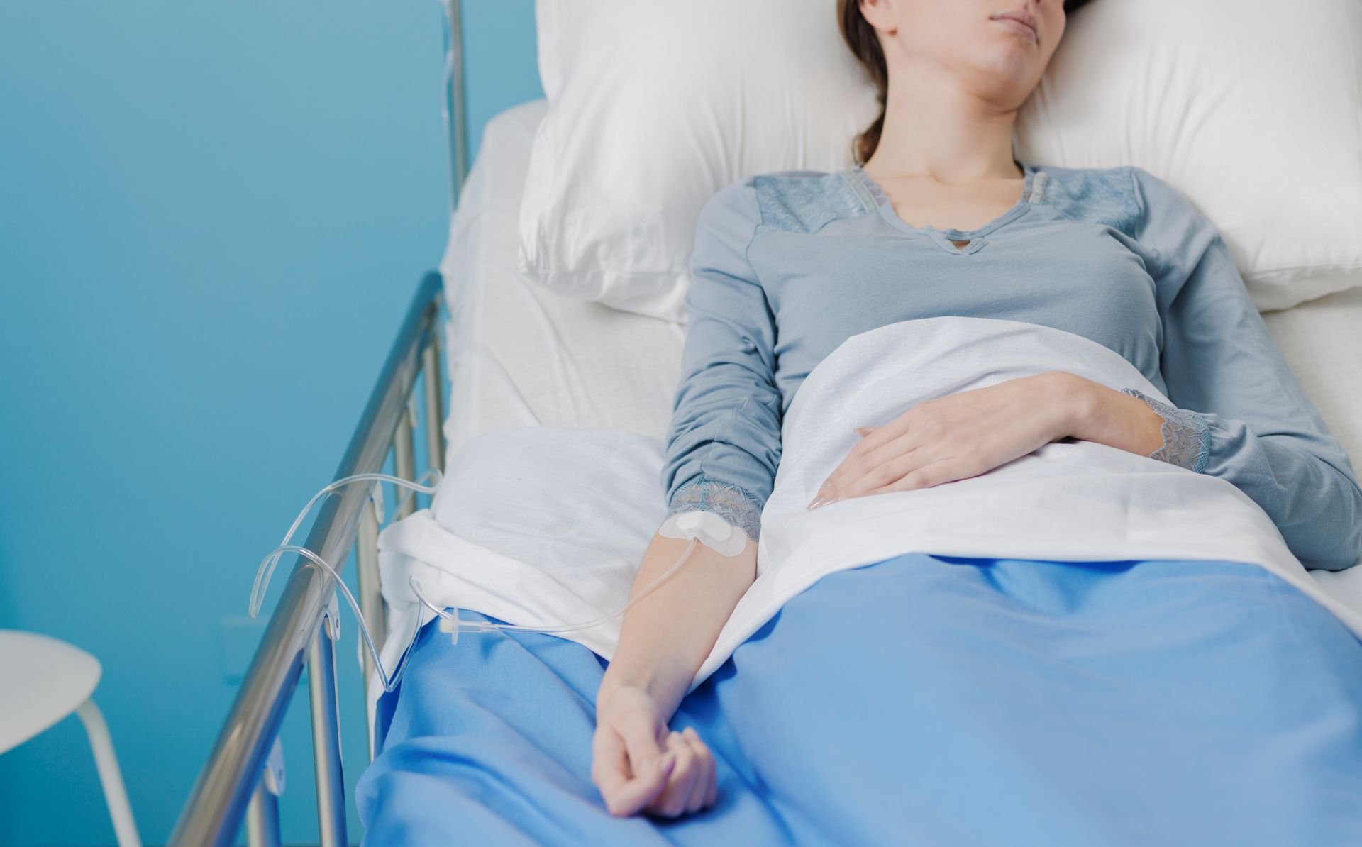 Patient in a hospital bed with IV drip