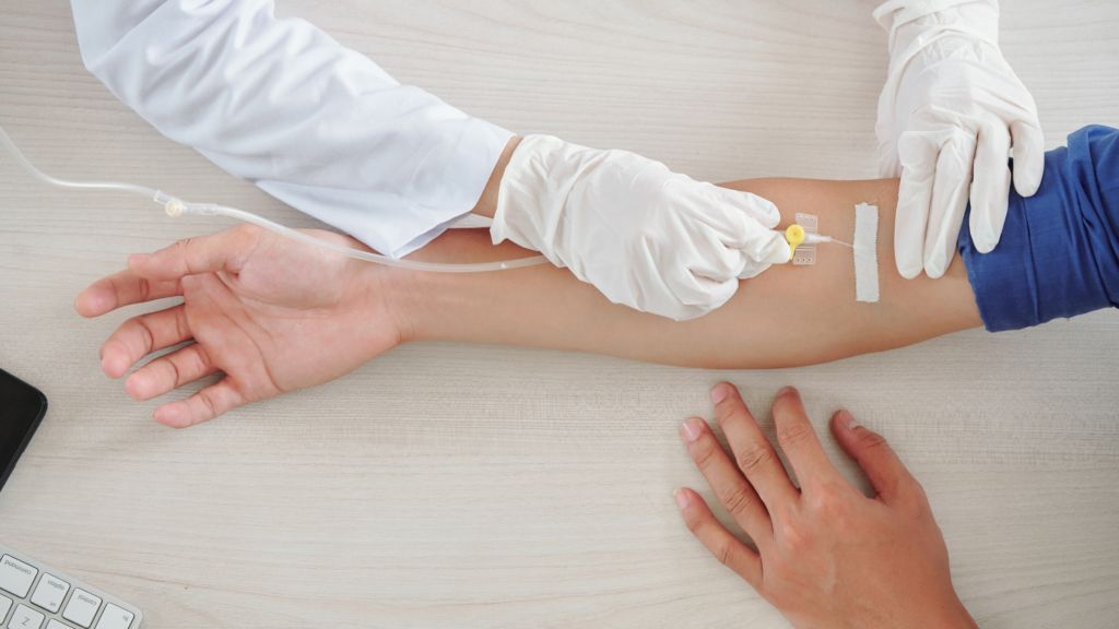a person is getting an injection in their arm