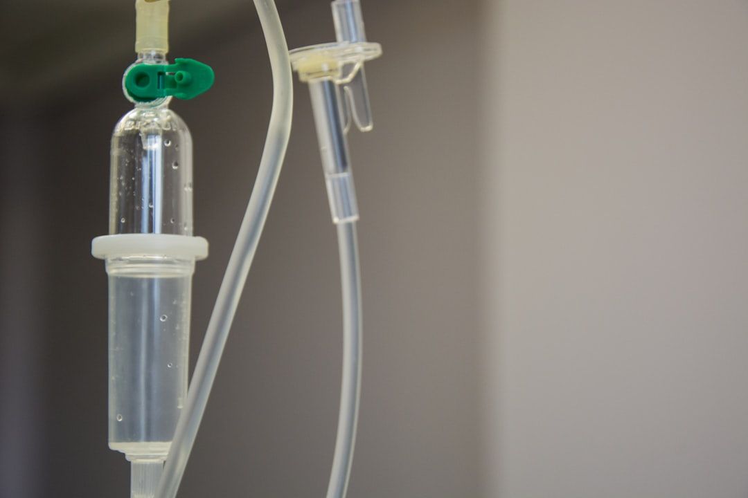 A close up of an iv drip in a hospital room.