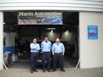 Three mechanics standing at the entrance of Marin Automotive garage | Marin Automotive