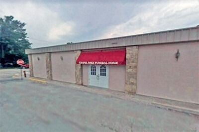 Single-story beige building with a red awning labeled