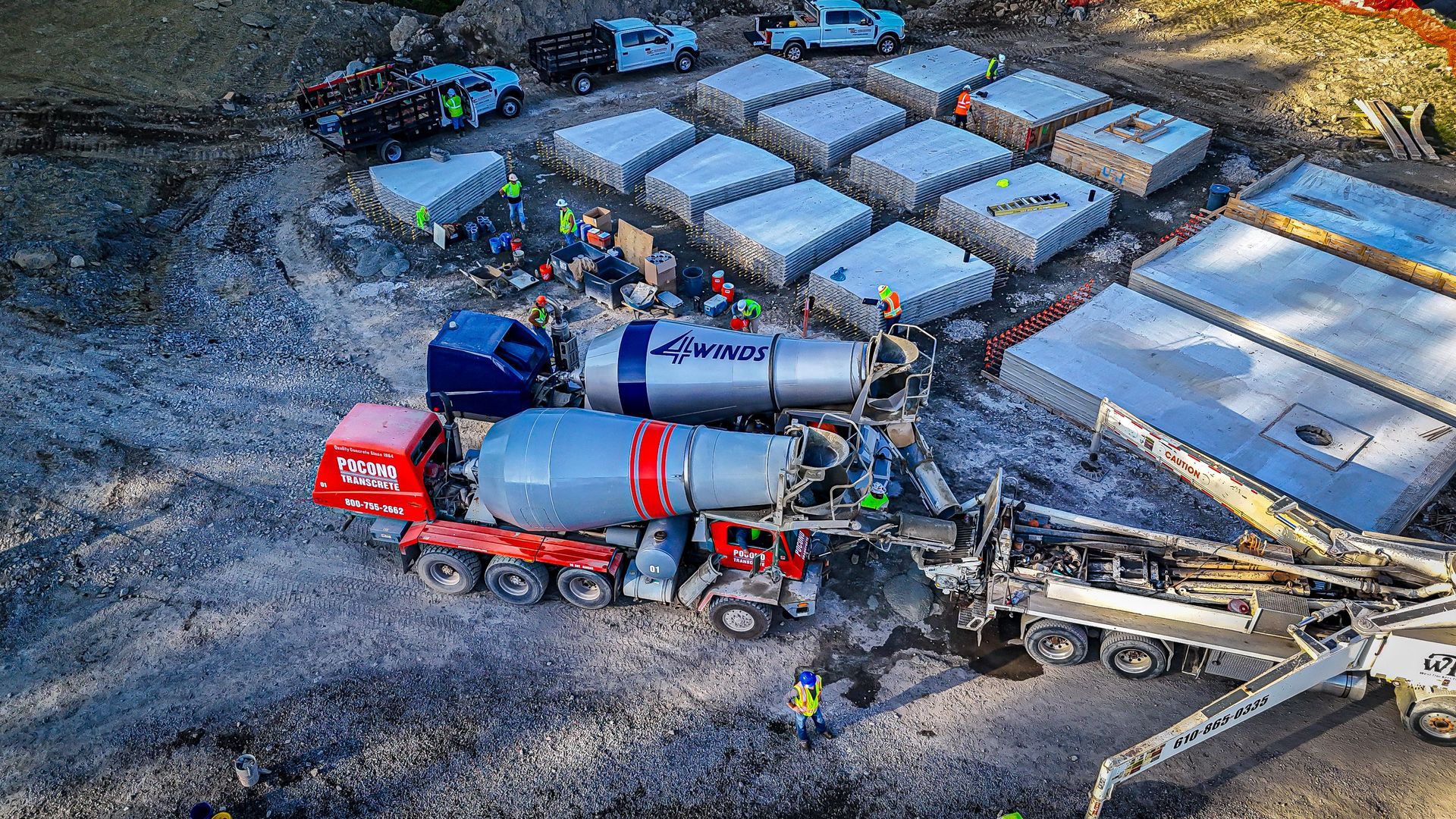 A construction site with a concrete mixer and a pump — Bethlehem, PA — 4 Winds Concrete Inc A construction site with a concrete mixer and a pump — Bethlehem, PA — 4 Winds Concrete Inc