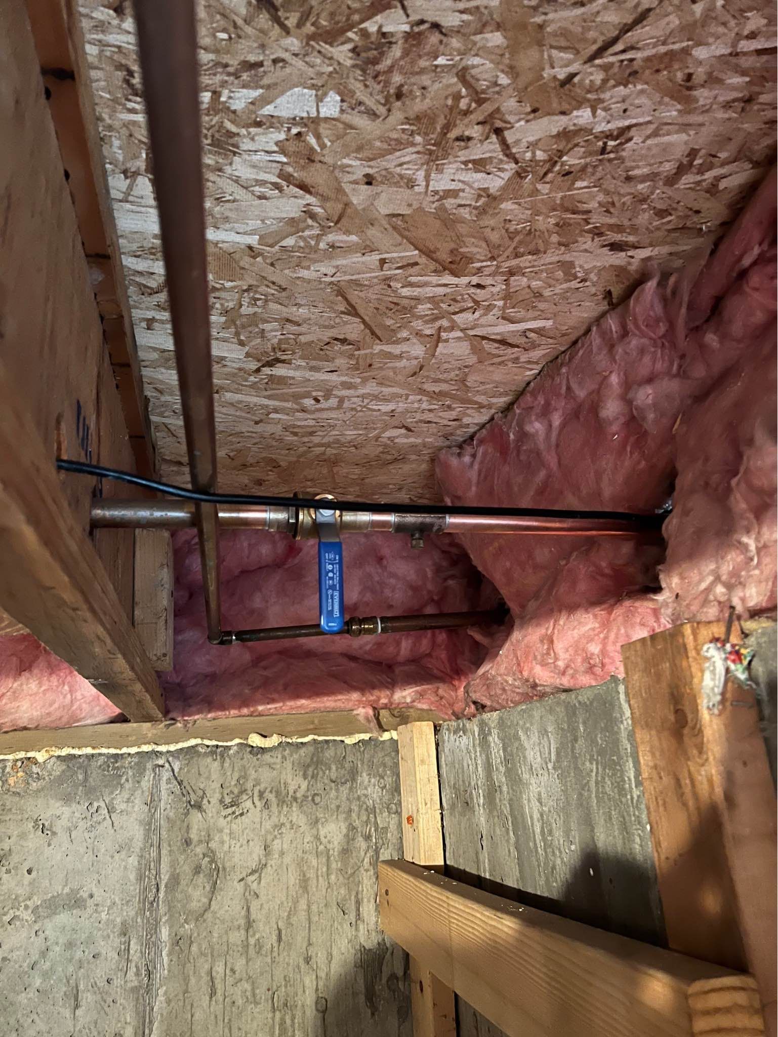 A pipe is being installed in the ceiling of a house.