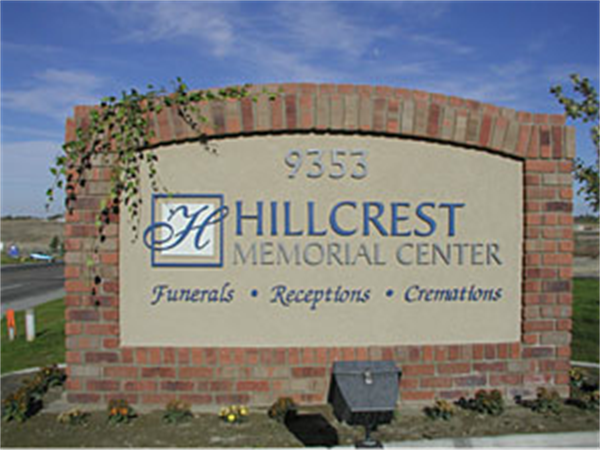 Brick sign for Hillcrest Memorial Center with address 9553 and services listed: funerals, receptions, cremations