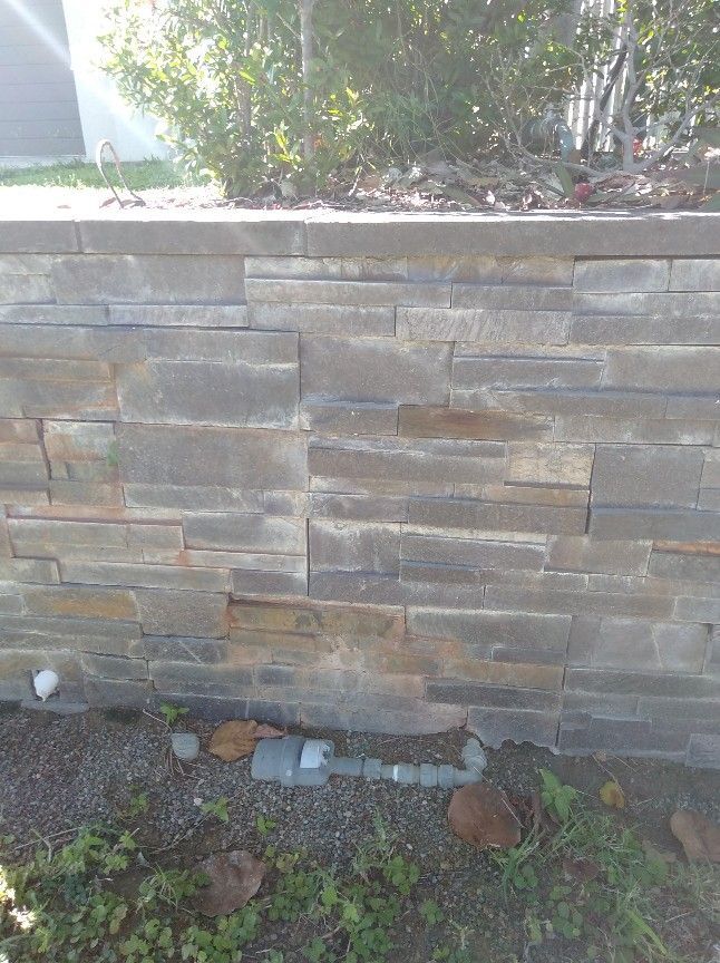 Water Pipe Installed Beneath a Retaining Wall — Irrigation in Townsville