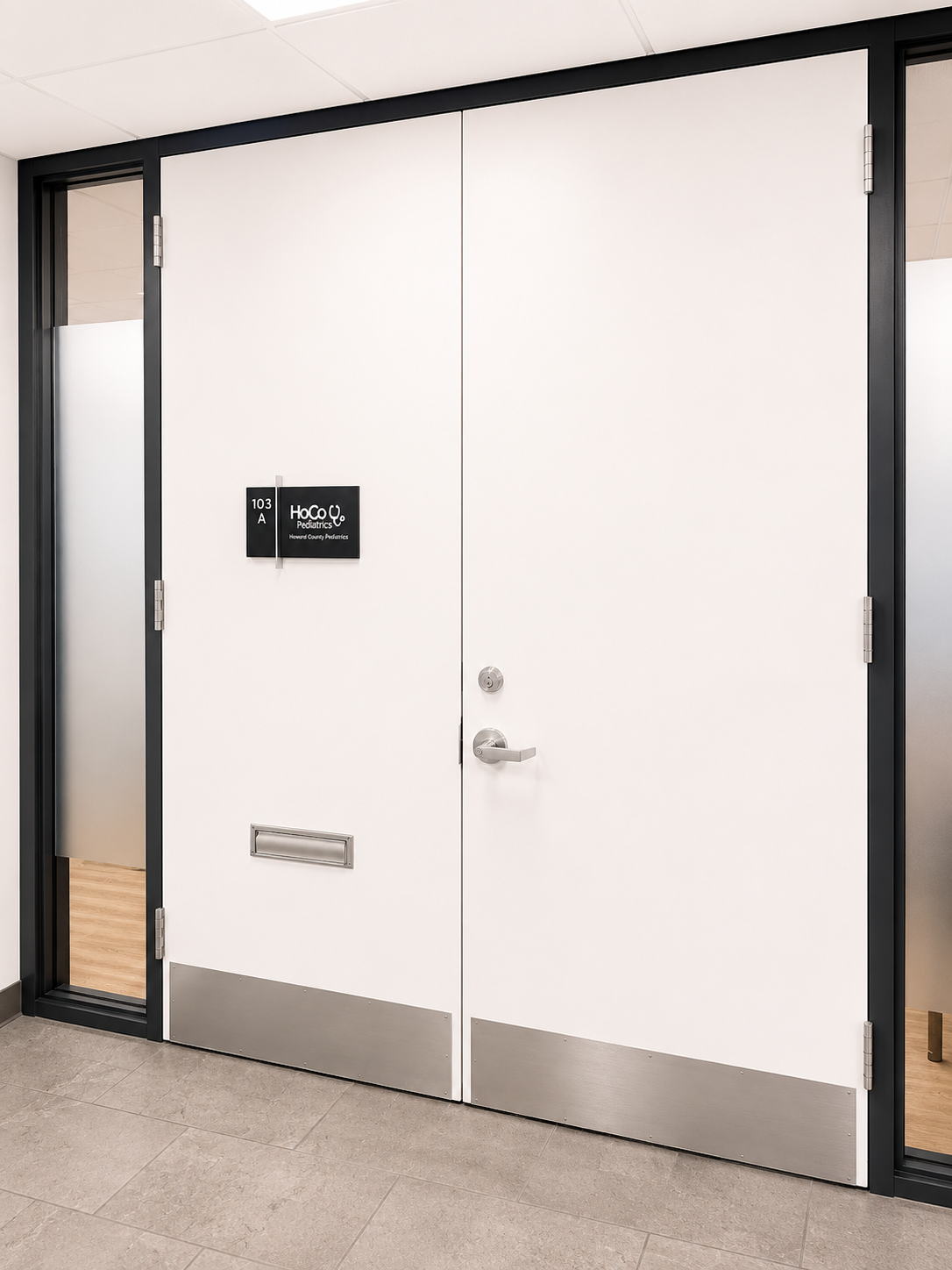 White double door with a keypad entry panel in a modern interior hallway.