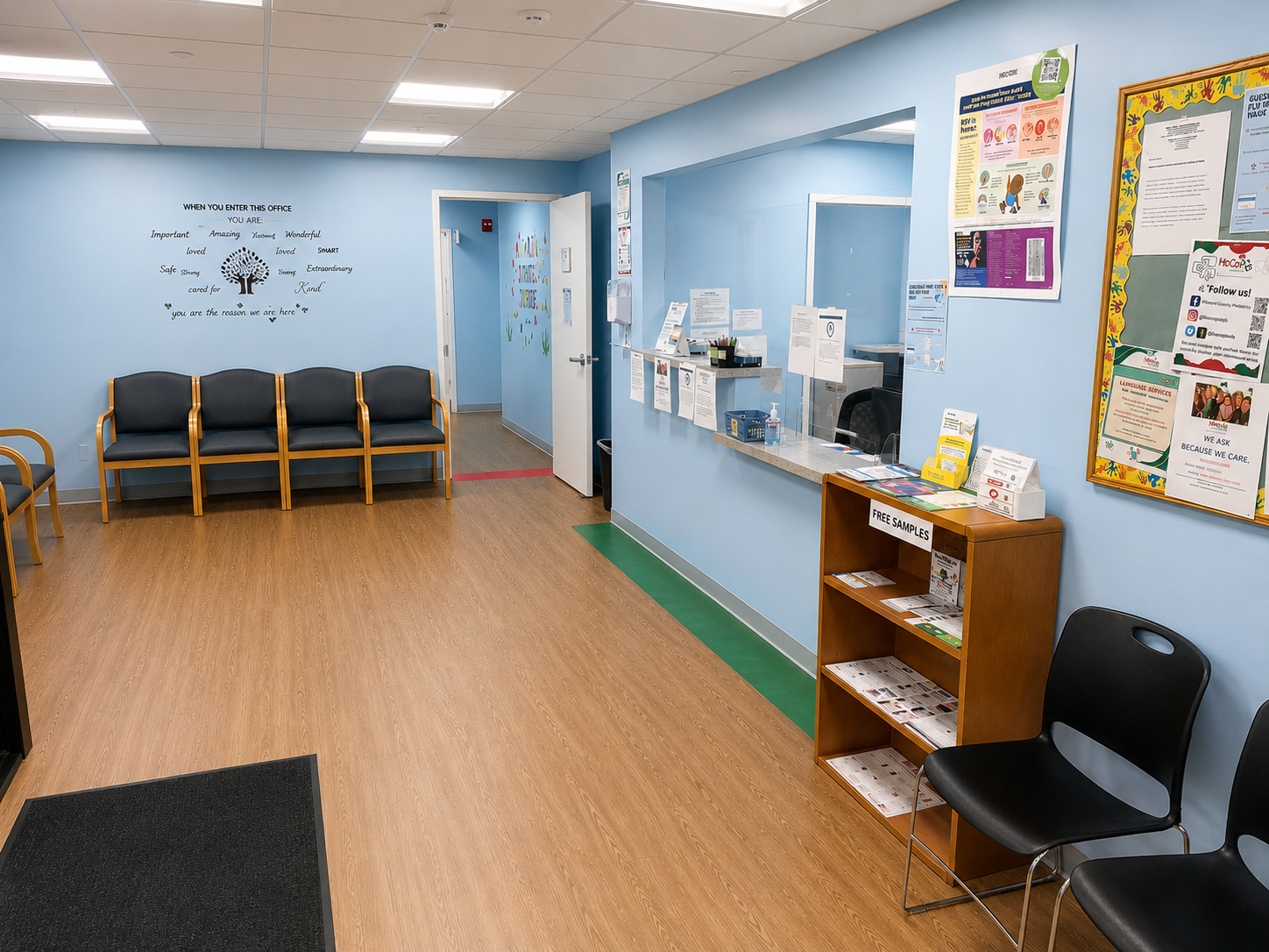 Blue waiting room with chairs, reception window, and bulletin boards