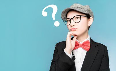 Person in glasses and a gray cap, wearing a black suit and red bow tie, looking thoughtful with a question mark nearby.