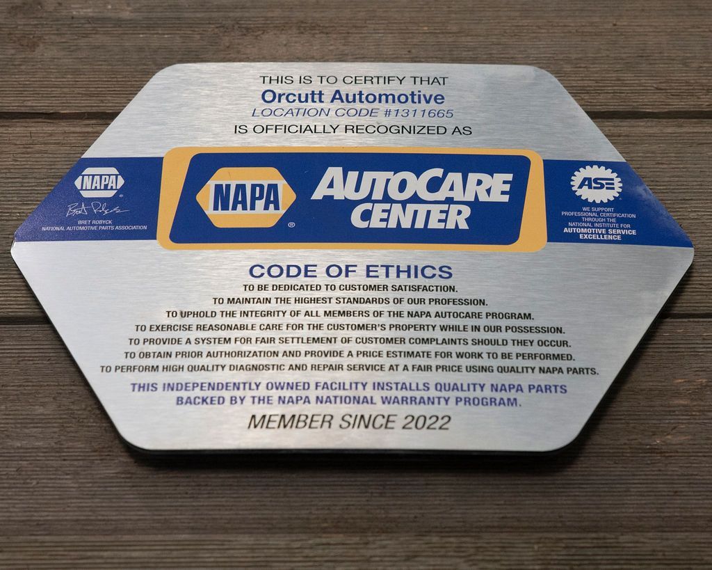 NAPA AutoCare Center countertop display with code of ethics and member since 2022 text