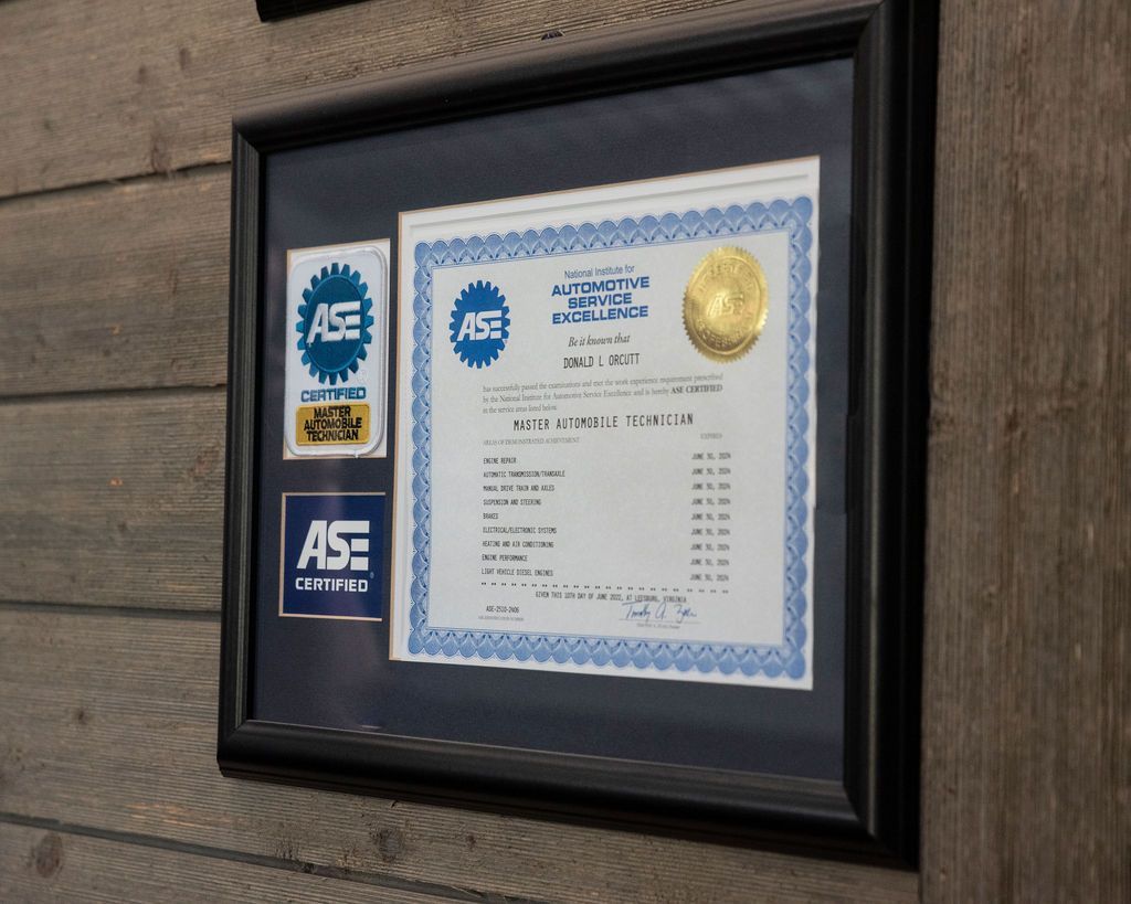Framed AE certificate with gold seal mounted on a wood wall